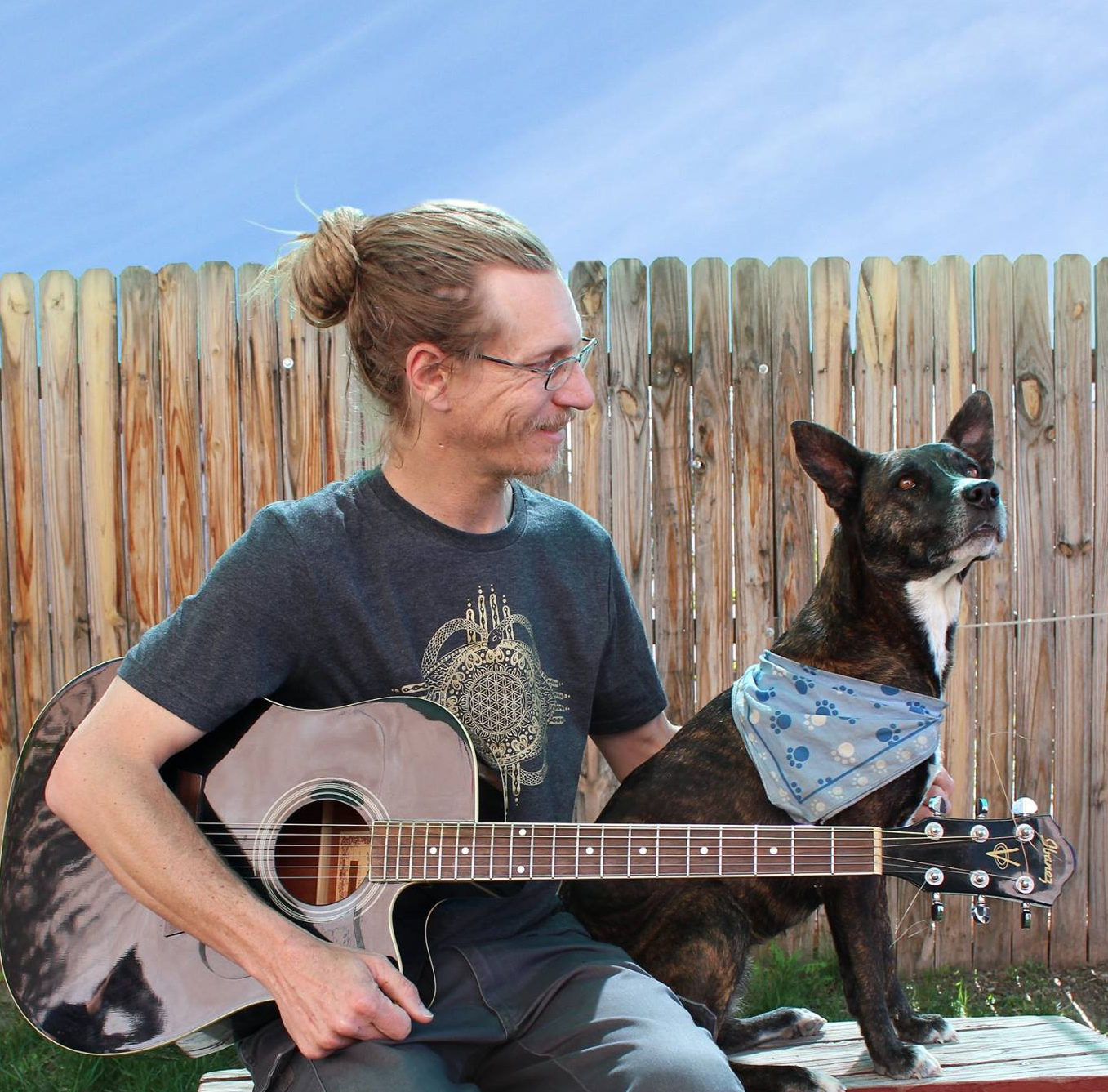 A pic of myself with a guitar and my dog Denali